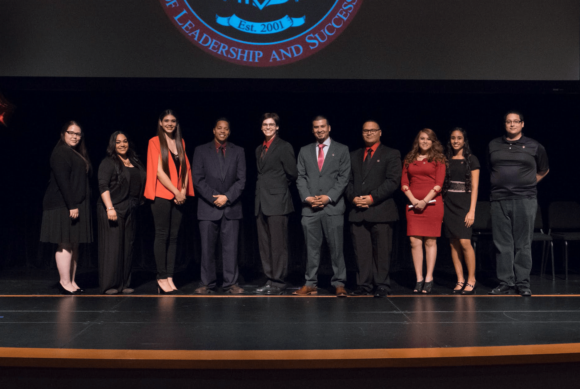 Students posing on stage