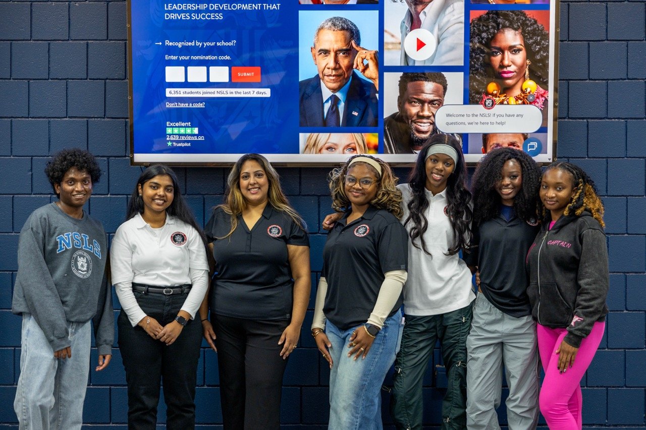 NSLS Members in front of a Speaker Broadcast Image.