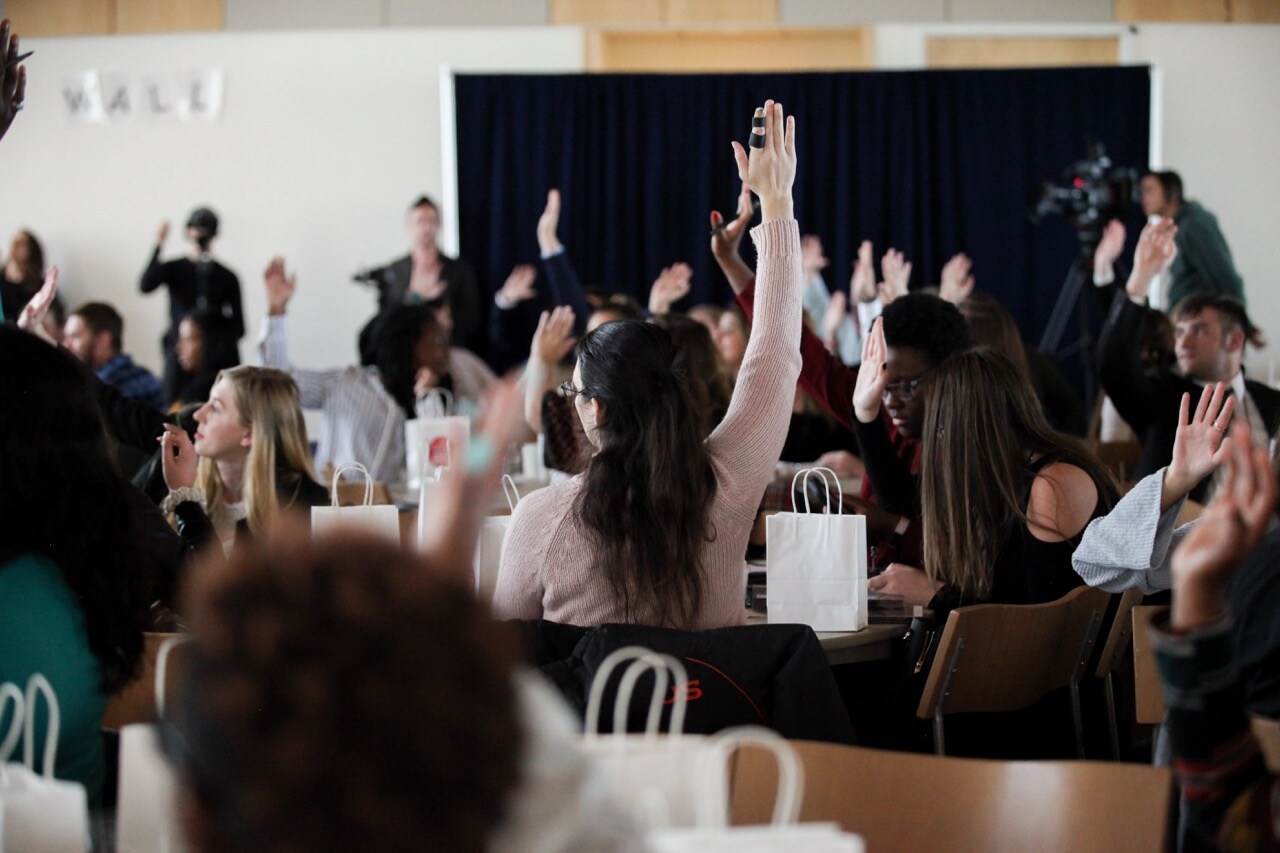 Conference Attendees Raising Their Hands. Large